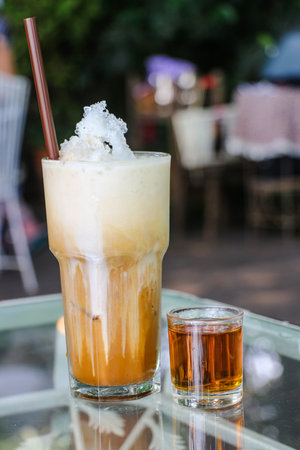 Ice coffee in glass with syrup - Cold coffee with fresh milk