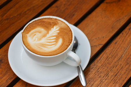 Close up of cappuccino coffee in wooden table
