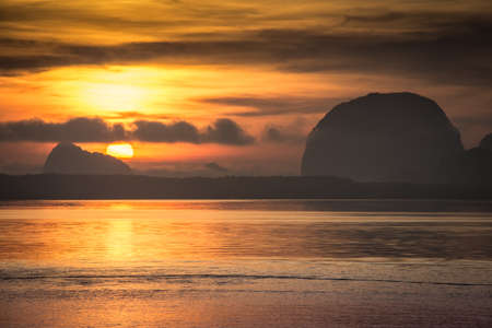 Landscape of beautiful nature sunrise at sea mountain backgroundの写真素材