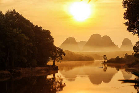 Sunset over lake in mountains backgroundの写真素材