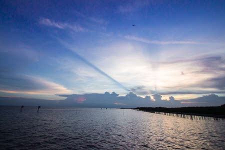 Landscape of beautiful sky at fisherman village in Thailand - Twilight sky in the seaの写真素材