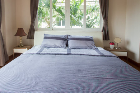 Close up of big comfortable double bed in modern bedroom