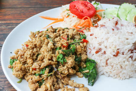Rice and stir fried pork holy basil (Thai food) - Close up of rice topped with stir fried minced pork and holy basilの写真素材