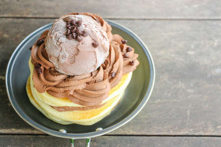 Stack of Homemade Pancakes with Chocolate Ice-Cream Scoops on Wooden Backgroundの写真素材