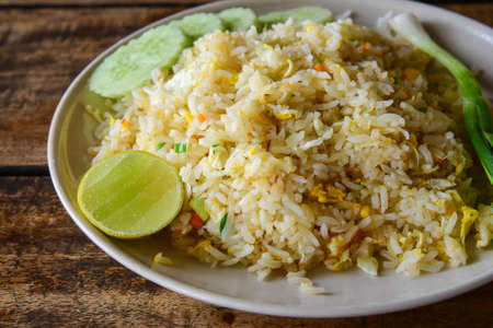 Fried rice with eggs on wooden table - Thai cuisineの写真素材