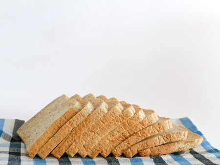 Sliced bread on white background. Sliced homemade bread. Whole grain or whole wheat bread.の写真素材