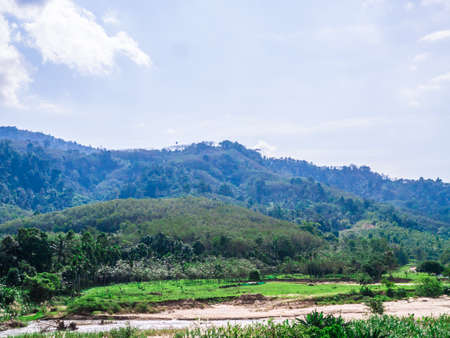 Mountain, river, and blue sky in Lansaka, Nakhon Si Thammarat, Thailand. Beautiful green landscape.の写真素材