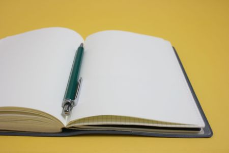 A pen rest on an organizerの写真素材