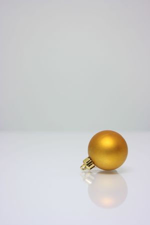 Christmas ornament, matte gold ball on the floorの写真素材