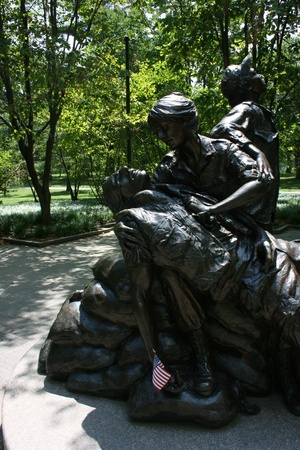 Washington DC,USA, July 22,2010 â Vietnam Veteran's Memorial, Bronze statue of wounded soldier holding the flag of Americaのeditorial素材