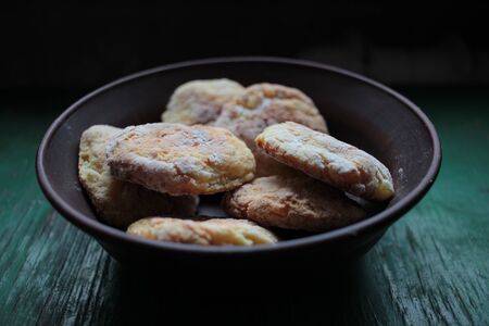 Healthy natural homemade cookies in ceramic bowl on dark rustic wooden backgroundの写真素材