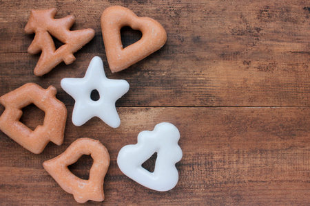Christmas background with gingerbread cookies on wooden table. Top view, copy space. Rustic style....