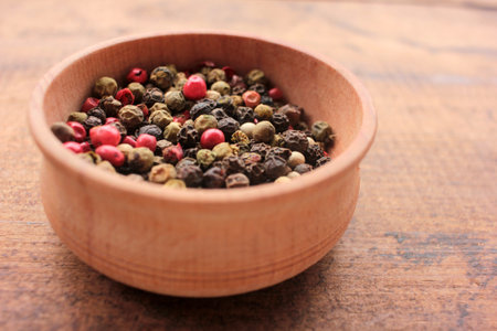 Various species multicolored peppers in wooden bowl, and dry red hot chili peppers on craft paper background. Top view, copy spaceの写真素材