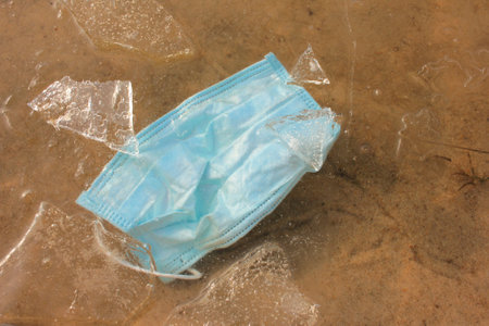 Blue protective mask on frozen river.の写真素材