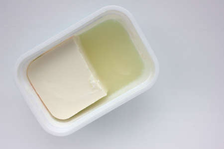 Soft feta cheese in plastick package on white background. Overhead viewの写真素材
