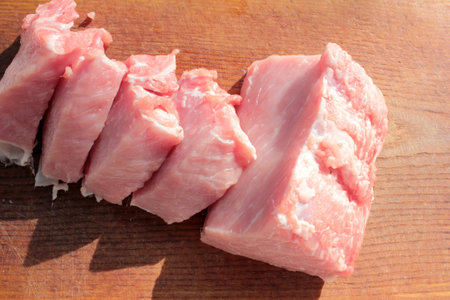 Raw pork meat chops on a wooden board. Top view. Preparation for cooking