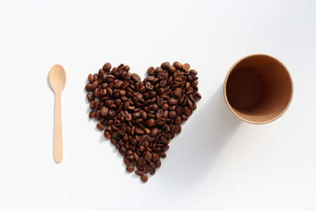 Heart shaped coffee beans on white table background. Top view, copy space. I love coffee conceptの写真素材