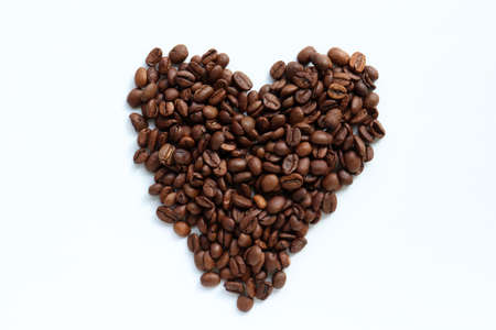 Heart shaped coffee beans on white table background. Top view, copy spaceの写真素材