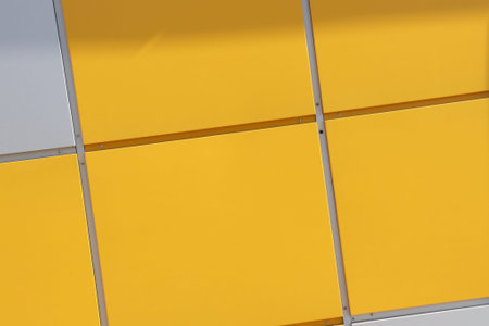Close up of bright yellow wall with gray panels. Geometric backgroundの写真素材