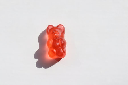 Red gummy bear jelly candy on white background. Top view, copy spaceの写真素材