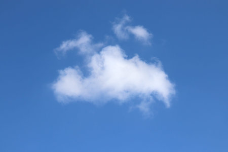 Blue sky with white fluffy clouds. Natural background with copy space.