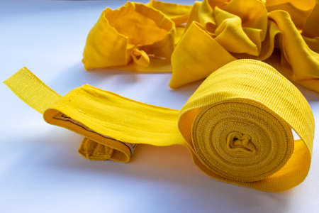 Yellow boxing hand bandage wraps on white background. Sports equipment for boxing. Top view, copy spaceの写真素材