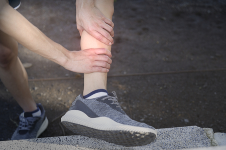 The runner injured the calf while practicing.の写真素材