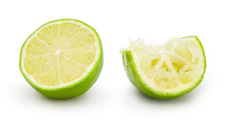 Fresh lime cut in half with drop shadow on white background. Commercial image of citrus fruits isolated with clipping path.の写真素材