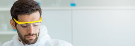 The face of the scientist wearing eye protection glassesの写真素材