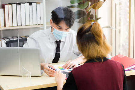 Asian male employees worked in offices during the outbreak of the coronavirus (COVID-19)の写真素材