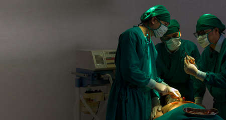 The surgeon's team with surgical tools making thoracic surgery in the operation room in critically ill cases.の写真素材