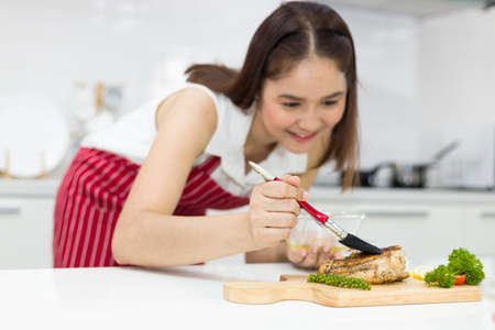 Young Asian woman happy cooking for themselves.の写真素材