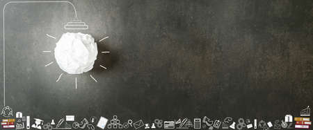 Concepts of intelligence, Education, Creativity, and new innovation. Crumpled lump of white paper like a light bulb white glow with illustration on vintage concrete background.の写真素材