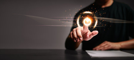 Man's hand pushing a button to turn off the switch Reduce energy consumption, conservation concept, global warming, reduce fossil and coal energy use. Focus on developing clean energy.の写真素材