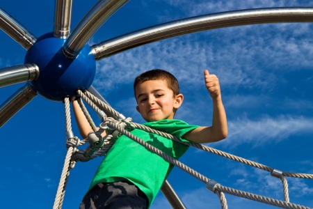 Child playing on the play structure in the parkの写真素材