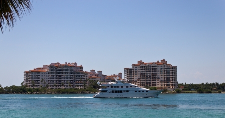 Luxury yatch sails past Fisher Island in Miami, Floridaのeditorial素材