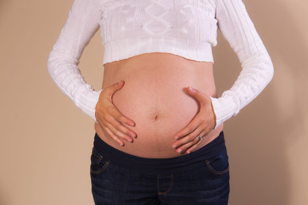 Front view of exposed belly of a pregnant woman