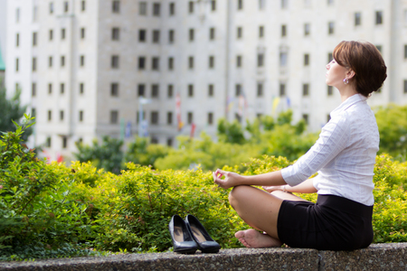 Business woman relaxing with yoga in the cityの写真素材