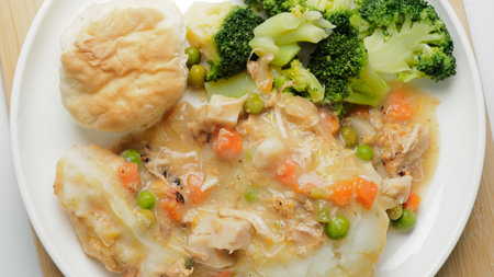 Fried chicken with vegetables on white plate. Close-up.の写真素材