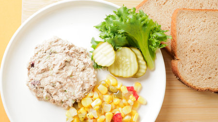 Tuna salad with corn and cucumber on white plate, stock photoの写真素材