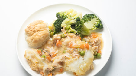 chicken stew with mashed potatoes and vegetables on a white background.の写真素材