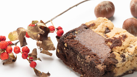 Chocolate cake with nuts and berries on a white background close upの写真素材