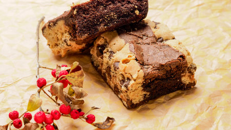 Chocolate cake with nuts on a paper backgroundの写真素材