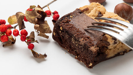 Chocolate cake with nuts and red berries on a white background.の写真素材