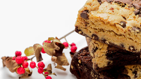 Chocolate chip cookies and red berries on a white background with copy spaceの写真素材