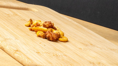 Nuts on a wooden cutting board on a black backgroundの写真素材