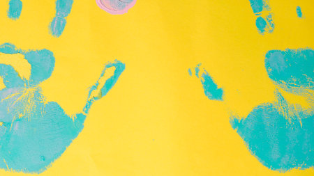 The texture of the paper is painted with blue and yellow paint.の写真素材