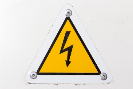 A high voltage sign on a white wallの写真素材