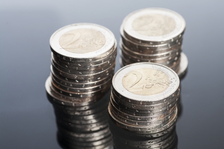 Two euros coins on a glass tableの写真素材