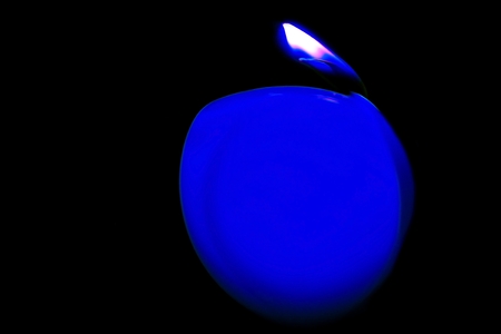 Blue candle in the dark の写真素材